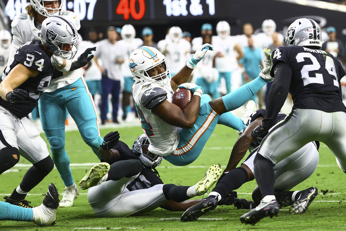 Miami Dolphins quarterback Jacoby Brissett (14) is stopped short at the end zone by the Raiders ...