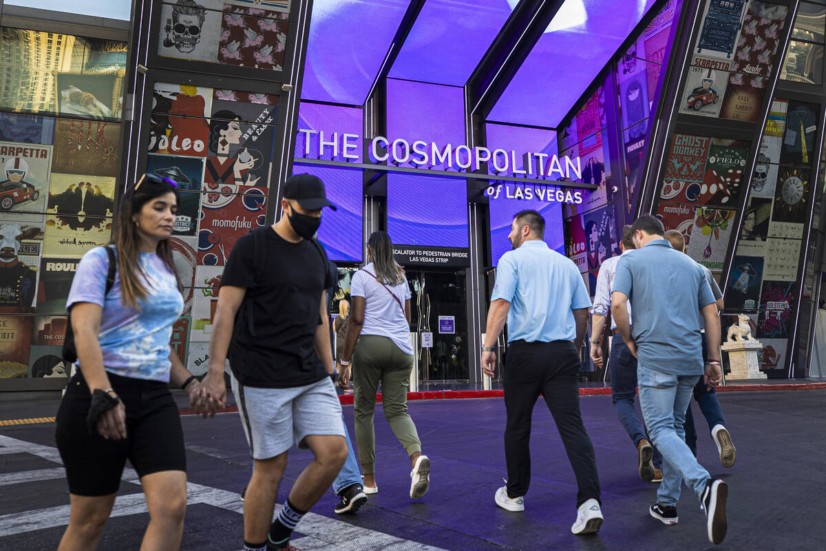 Pedestrians walk past The Cosmopolitan of Las Vegas on Monday, Sept. 27, 2021, in Las Vegas. (B ...