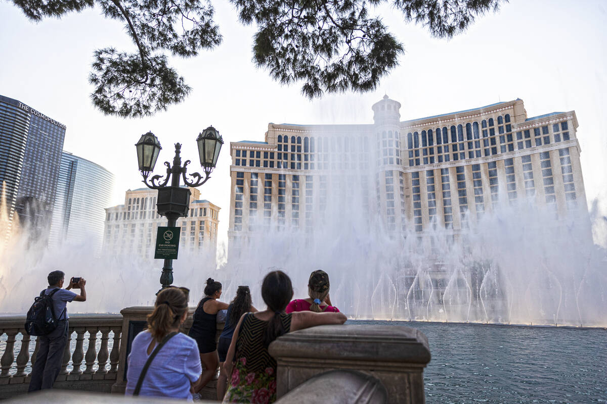 Pedestrians watch the fountain show at Bellagio on Monday, Sept. 27, 2021, in Las Vegas. (Benja ...
