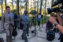 Attorney Deveraux Cannick, representing R&B star R. Kelly, center, arrives at Brooklyn Federal ...