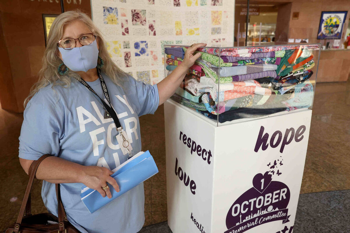 Trish Elliott of North Las Vegas, who donated 13 quilts, with a display that is part of the 1 O ...