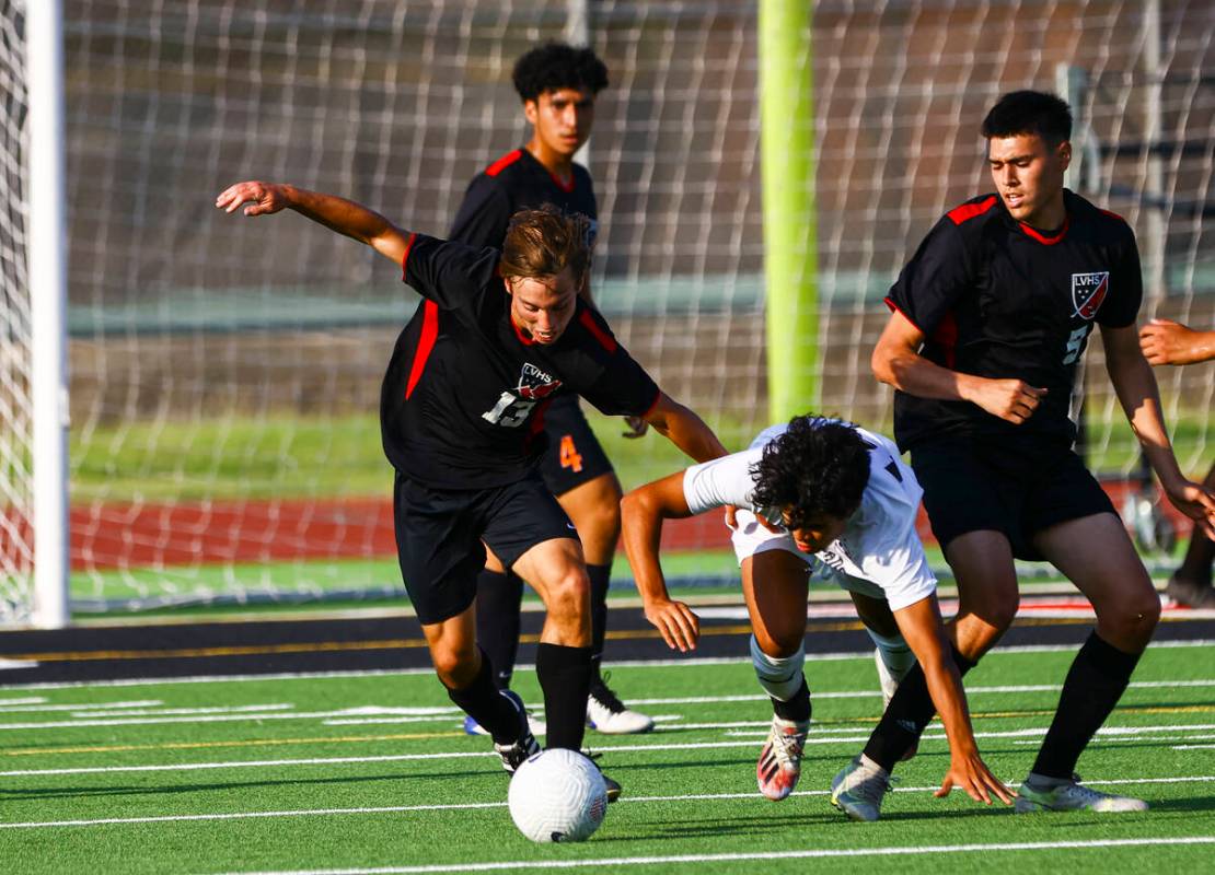 Las Vegas' Keaton McCoy (13) moves the ball as Coronado's Isaac Carcamo tries to keep up during ...