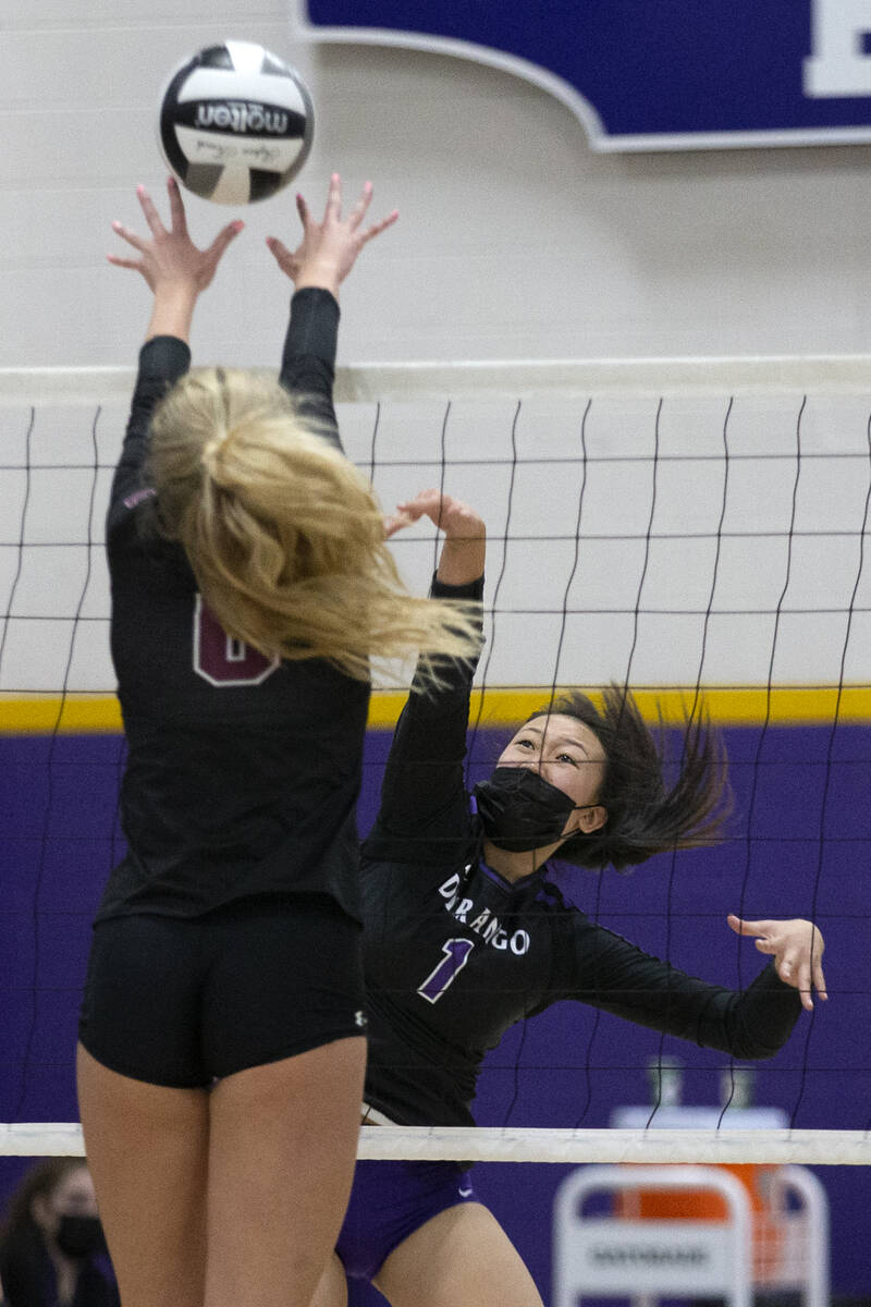 Durango's Alexa Yang (1) spikes as Faith Lutheran's Bianca Richardson (6) jumps to kill during ...