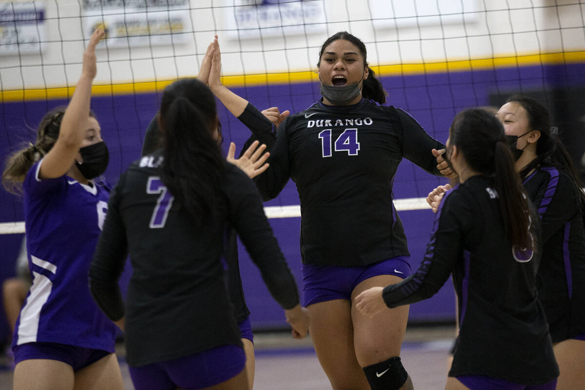 Durango celebrates a point scored, including Drazelle Ilaoa (14), during a high school volleyba ...
