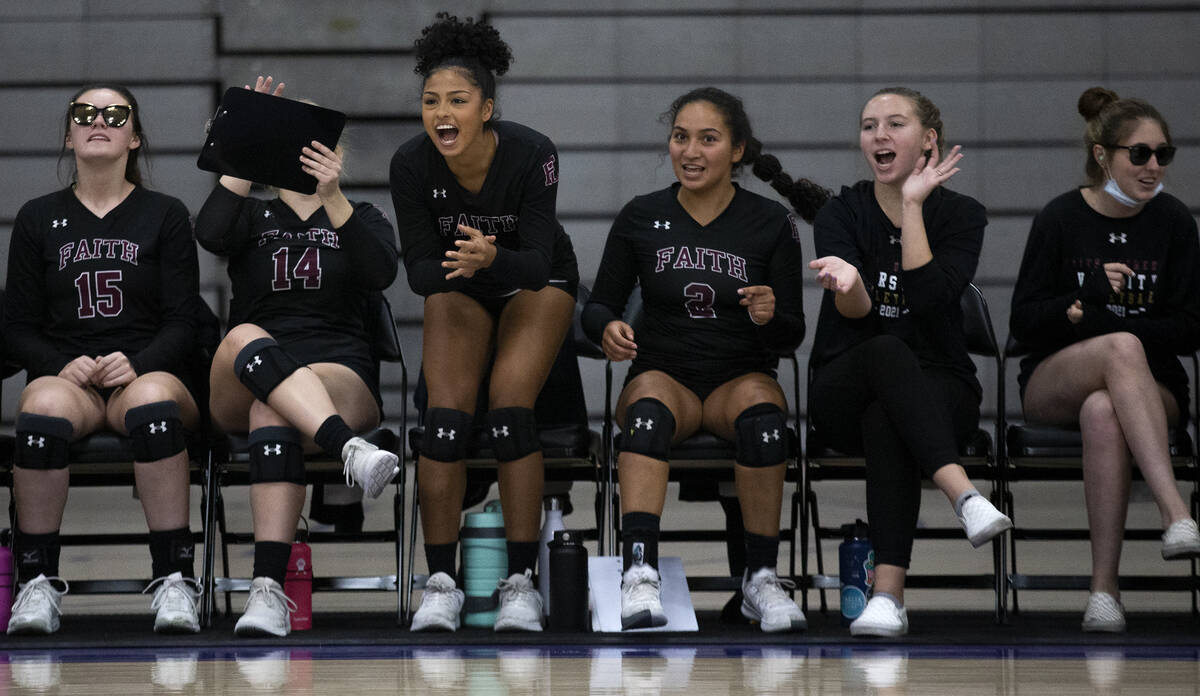 Faith Lutheran's bench cheers for their team during a high school volleyball game against Duran ...