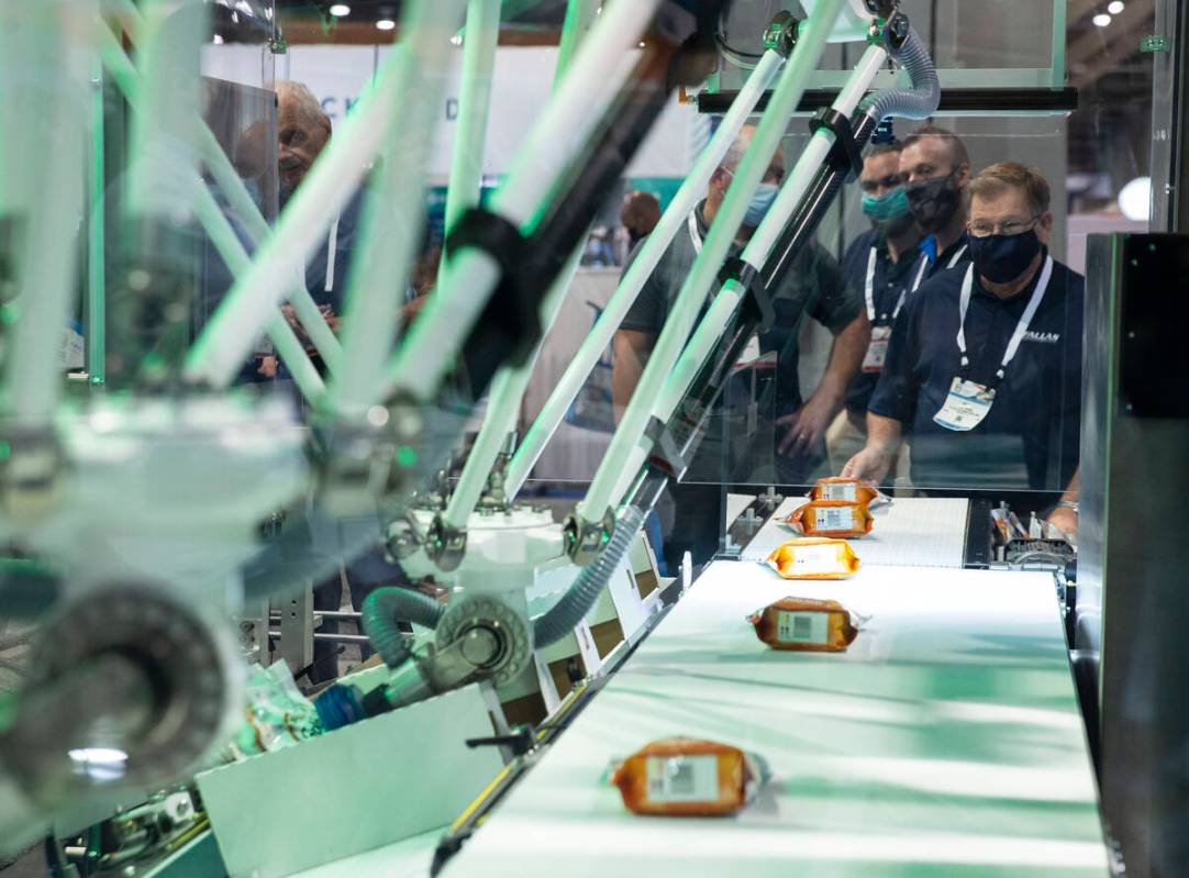 Mike Webb, of Fallas Automation Inc., operates Visibot-LV, top load case packer, during the PAC ...