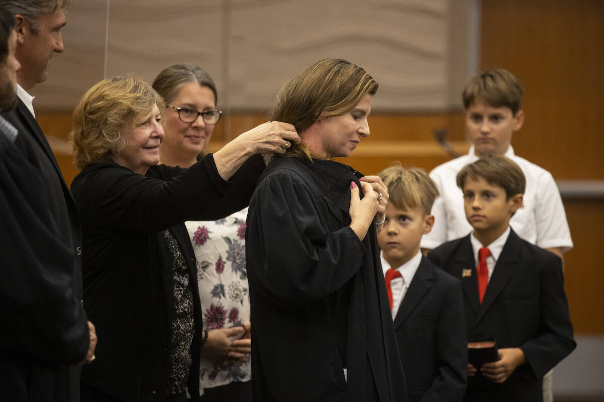 Rita Sisinger robes her daughter Judge Veronica Barisich during the Eight Judicial District Cou ...