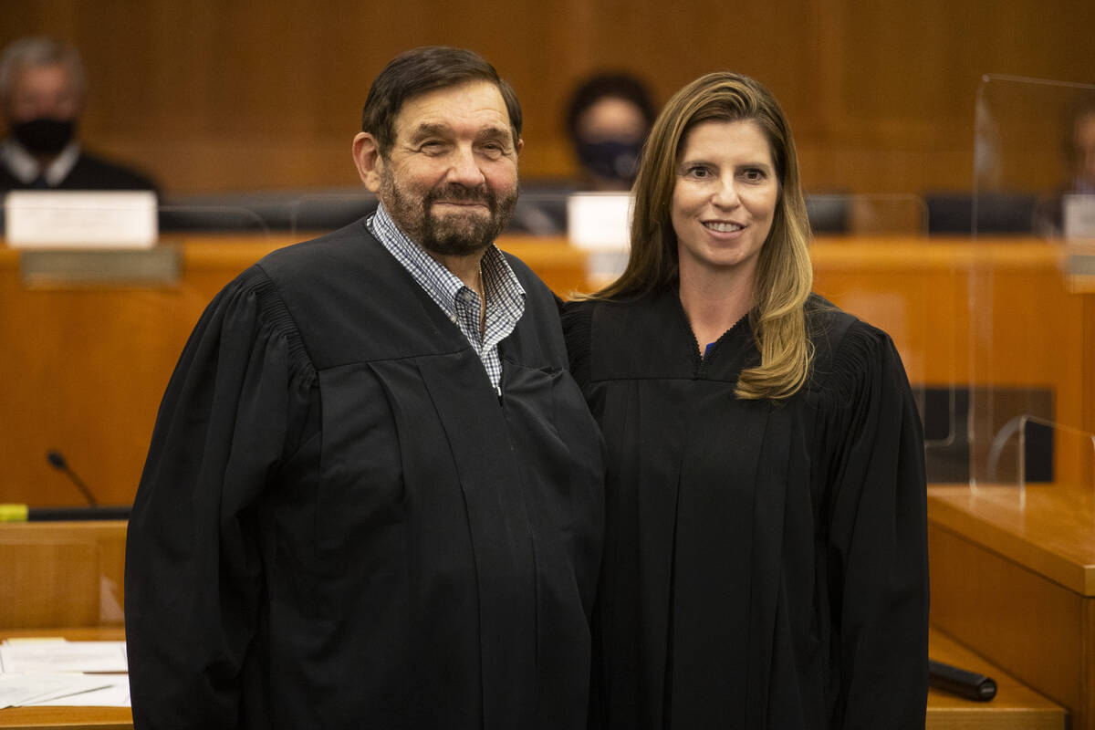Newly sworn in Judge Veronica Barisich, right, poses for a photo with Honorable Michael Cherry, ...