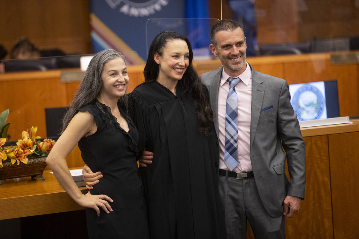 Judge Nadia Krall, center, with her husband Stephen, and sister Natalie Hudson, pose for a phot ...