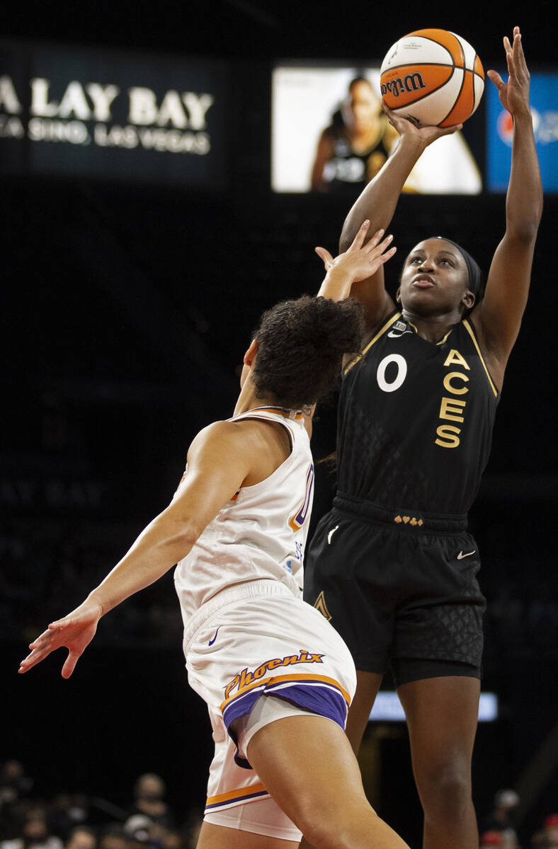 Las Vegas Aces guard Jackie Young (0) shoots over Phoenix Mercury guard Kia Nurse (0) in the fi ...