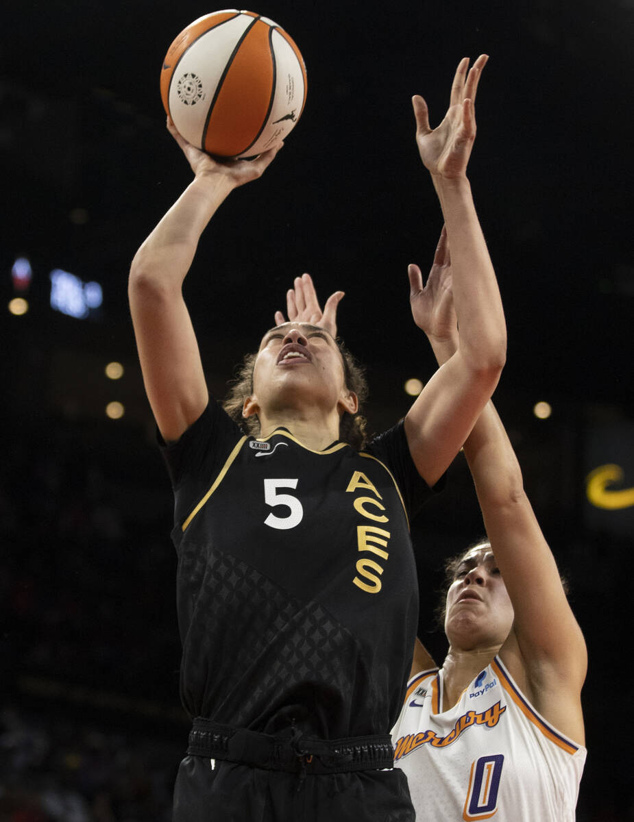 Las Vegas Aces forward Dearica Hamby (5) shoots over Phoenix Mercury guard Kia Nurse (0) in the ...