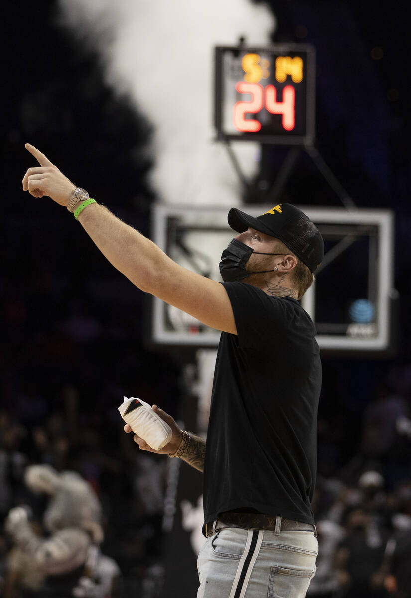 Raiders defensive end Maxx Crosby takes in the action between the Las Vegas Aces and Phoenix Me ...