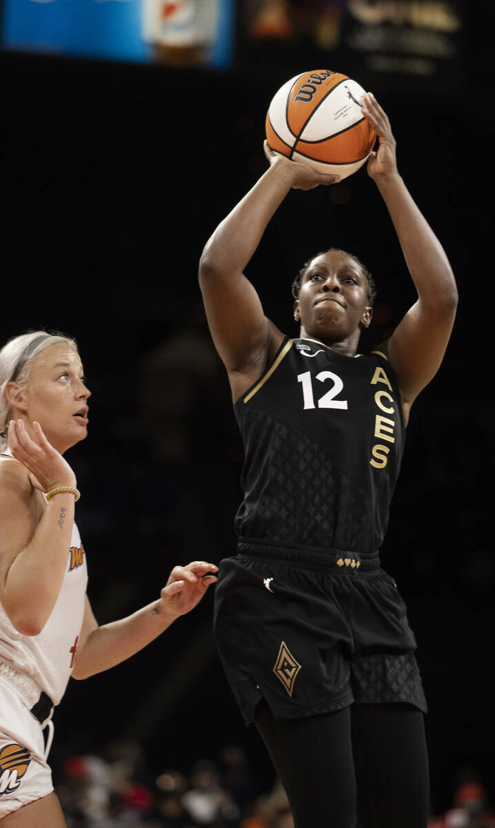 Las Vegas Aces guard Chelsea Gray (12) shoot over Phoenix Mercury guard Sophie Cunningham (9) i ...