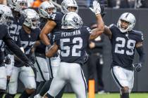 Las Vegas Raiders middle linebacker Denzel Perryman (52) gives a high five to Las Vegas Raiders ...