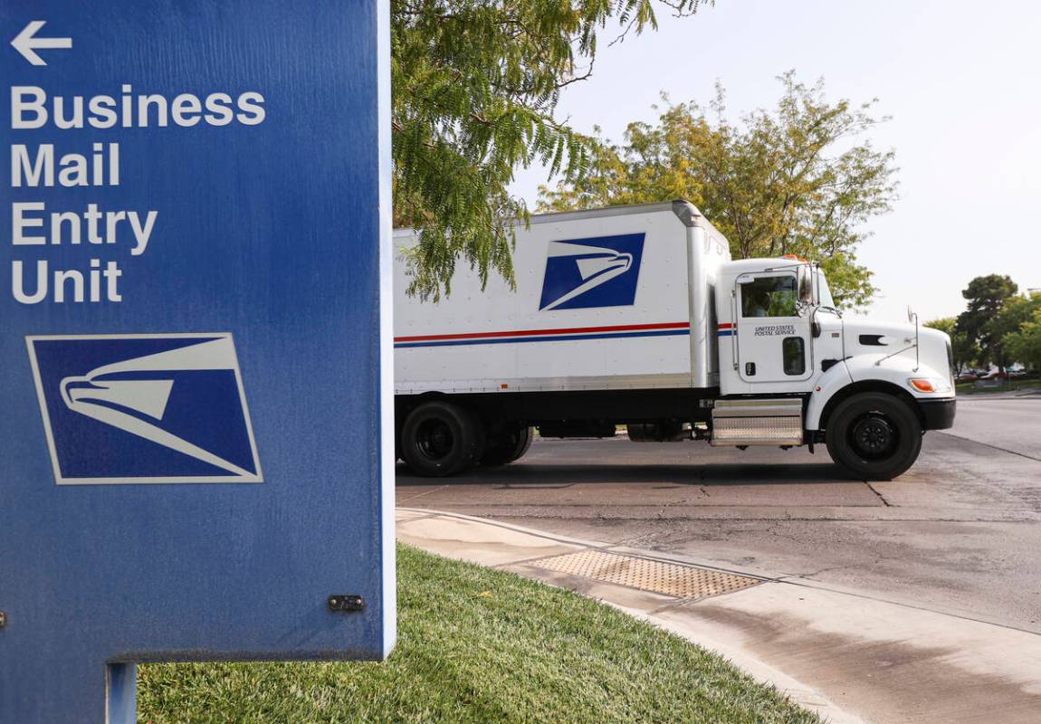 A truck departs from the U.S. Postal Service center at 1001 E. Sunset Road in Las Vegas on Thur ...