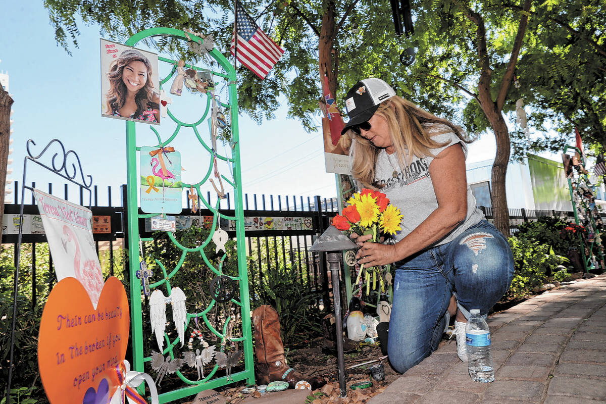 Alicia Mierke of Henderson places flowers at a dedication for Route 91 Harvest festival shootin ...
