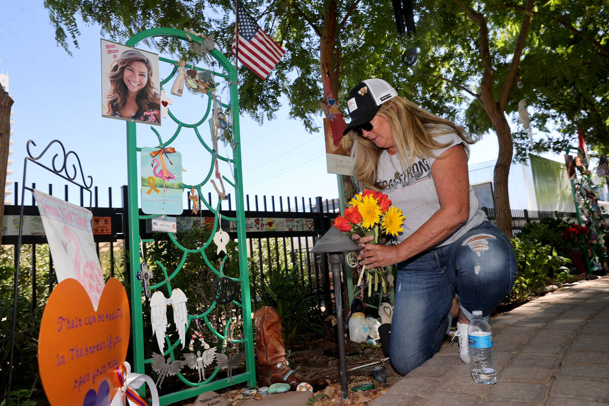 Alicia Mierke of Henderson places flowers at a dedication for Route 91 Harvest festival shootin ...