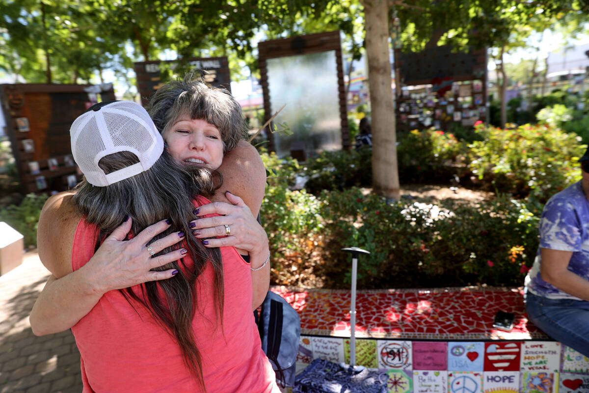 Sue Ann Cornwell, left, hugs Terri Keener at Las Vegas Community Healing Garden Thursday, Sept. ...
