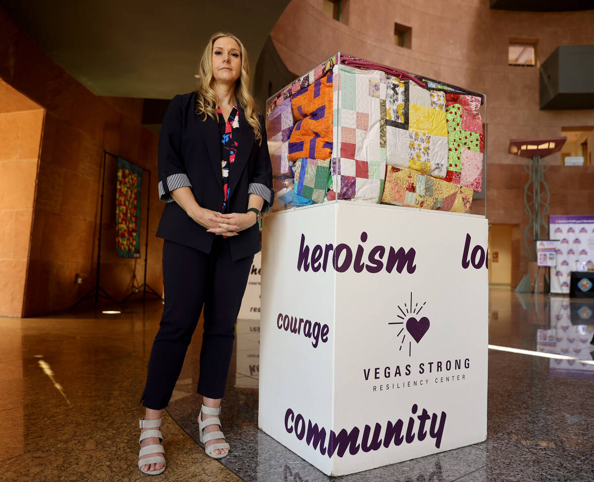 Tennille Pereira, director of Vegas Strong Resiliency Center, with an exhibit including donated ...