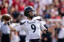 Cincinnati quarterback Desmond Ridder (9) throws during the first half of an NCAA college footb ...