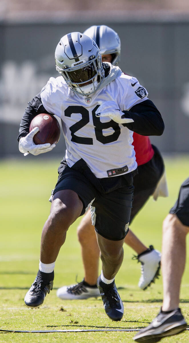 Raiders running back Josh Jacobs (28) runs with the football during a practice session at the R ...