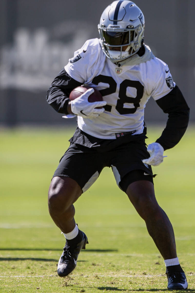 Raiders running back Josh Jacobs (28) runs with the football during a practice session at the R ...