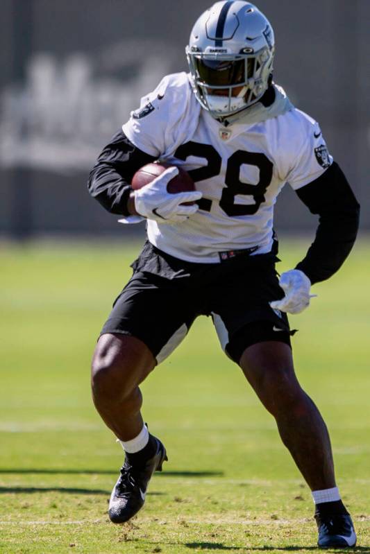 Raiders running back Josh Jacobs (28) runs with the football during a practice session at the R ...