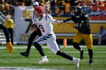 Cincinnati Bengals quarterback Joe Burrow (9) scrambles under pressure by Pittsburgh Steelers l ...