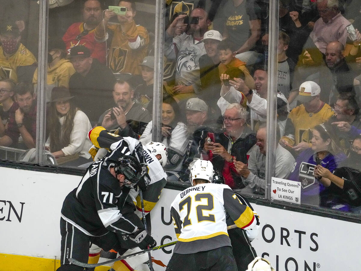 Fans try to get photos of a scrum as the Los Angeles Kings and the Vegas Golden Knights meet in ...