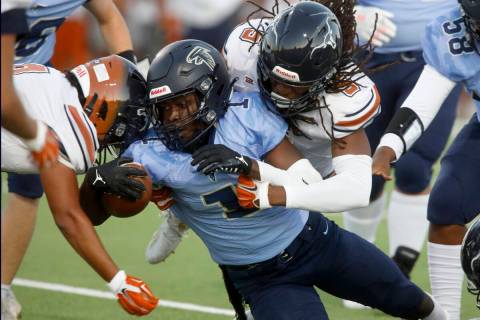 Foothill High School's Kendric Thomas (1) is tackled by Legacy High School's Daniel Thompson (9 ...