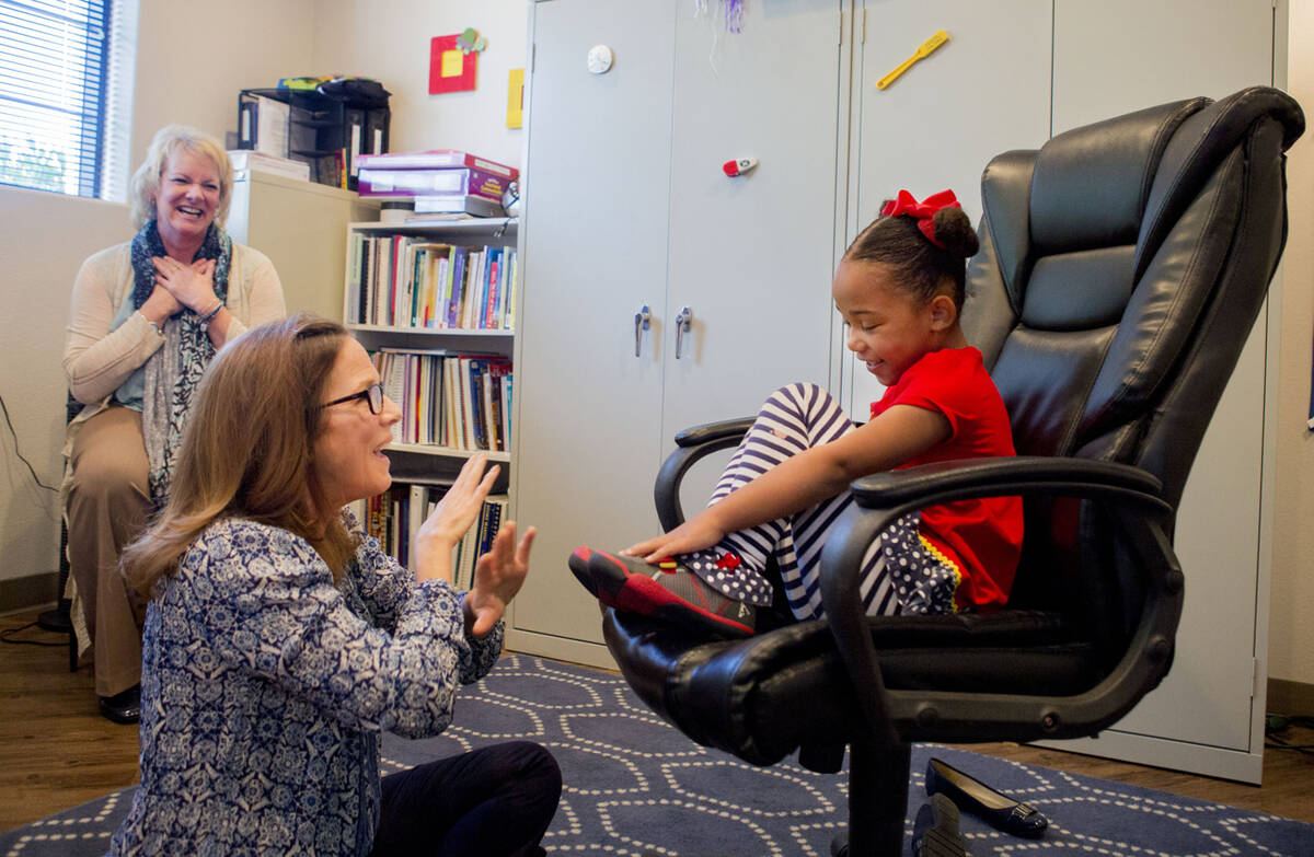 Client Hannah Beal, 4, and Julie Cole, a speech-language pathologist, engage in play therapy at ...