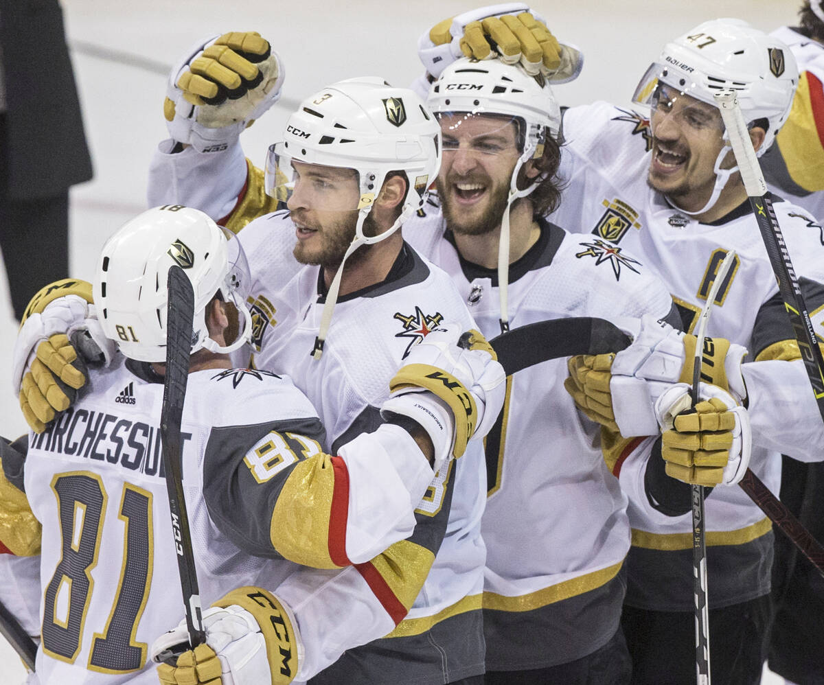 Golden Knights center Jonathan Marchessault (81) hugs teammates Brayden McNabb (3), Colin Mille ...