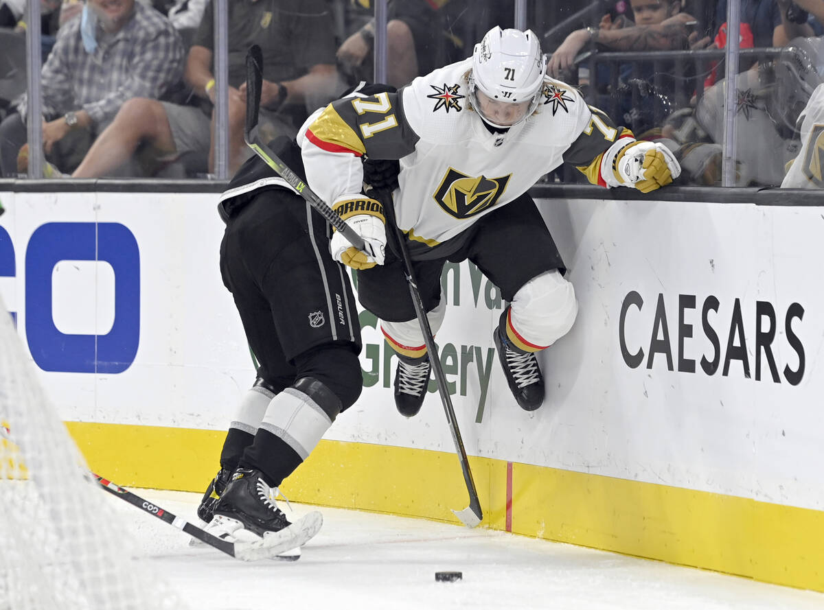 Vegas Golden Knights center William Karlsson (71) is held by Los Angeles Kings defenseman Kale ...