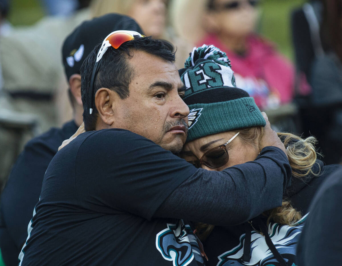 Roberto Ramirez comforts his wife Maria as they attend the annual 1 October Remembrance Ceremon ...
