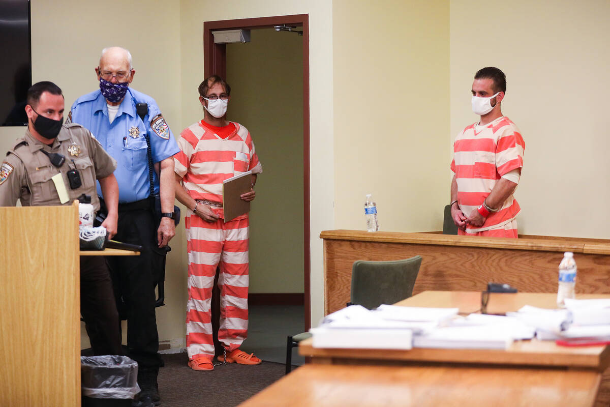 Brad Mehn, left, and Kevin Dent, center, get ready to be led out the courtroom after a prelimin ...