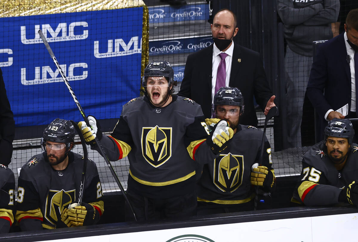 Golden Knights' Mattias Janmark, center, and head coach Pete DeBoer react to a call during the ...