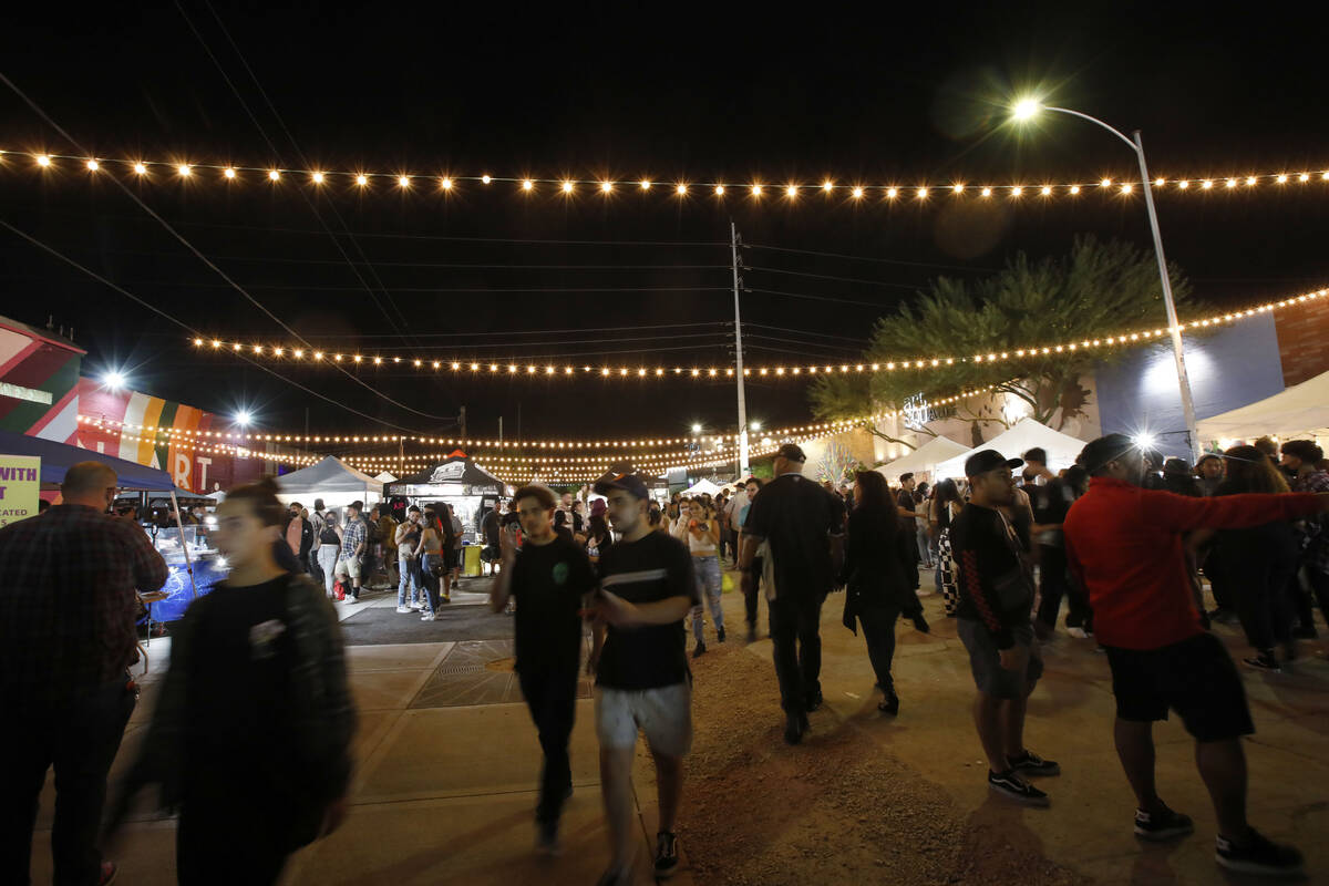 People walk around Art Square, Friday, Oct. 1, 2021, during First Friday in downtown Las Vegas. ...