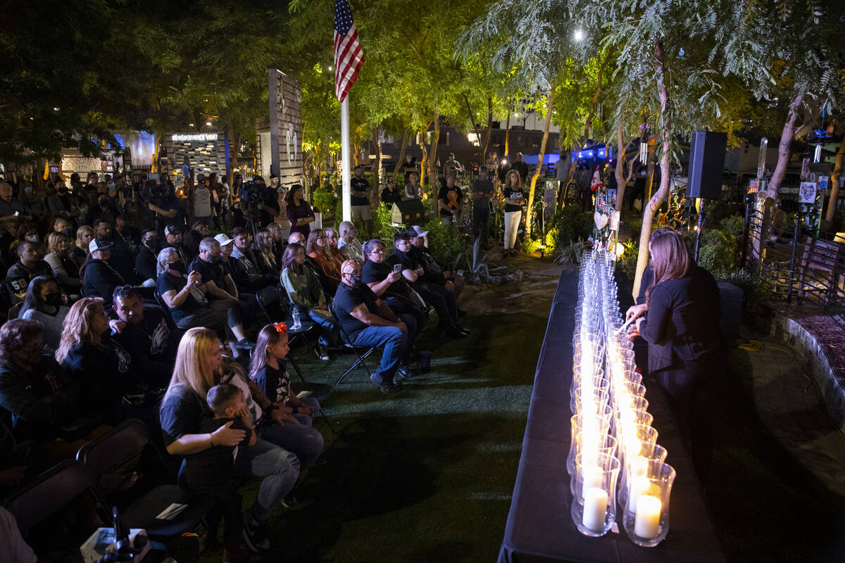 People participate during a ceremony remembering the victims from 1 October at the Las Vegas He ...