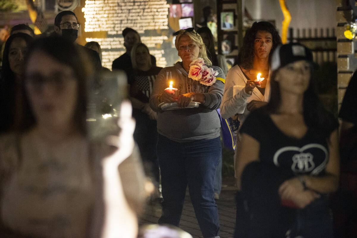 People participate during a ceremony honoring the victims from 1 October at the Las Vegas Heali ...