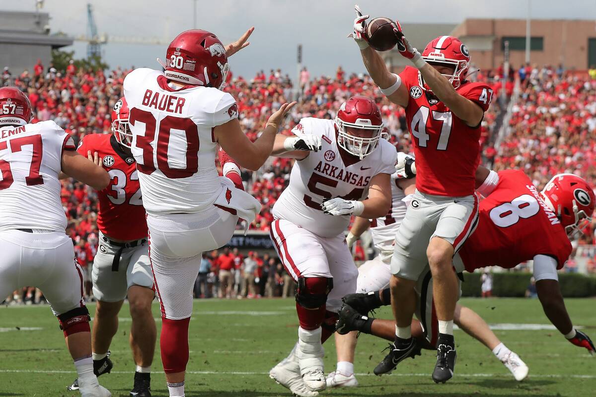 Georgia defensive back Dan Jackson blocks the punt in the endzone by Arkansas kicker Reid Bauer ...