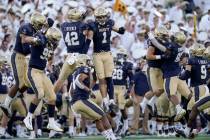 Navy players celebrate after they recovered a fumble by UCF during the second half of an NCAA c ...