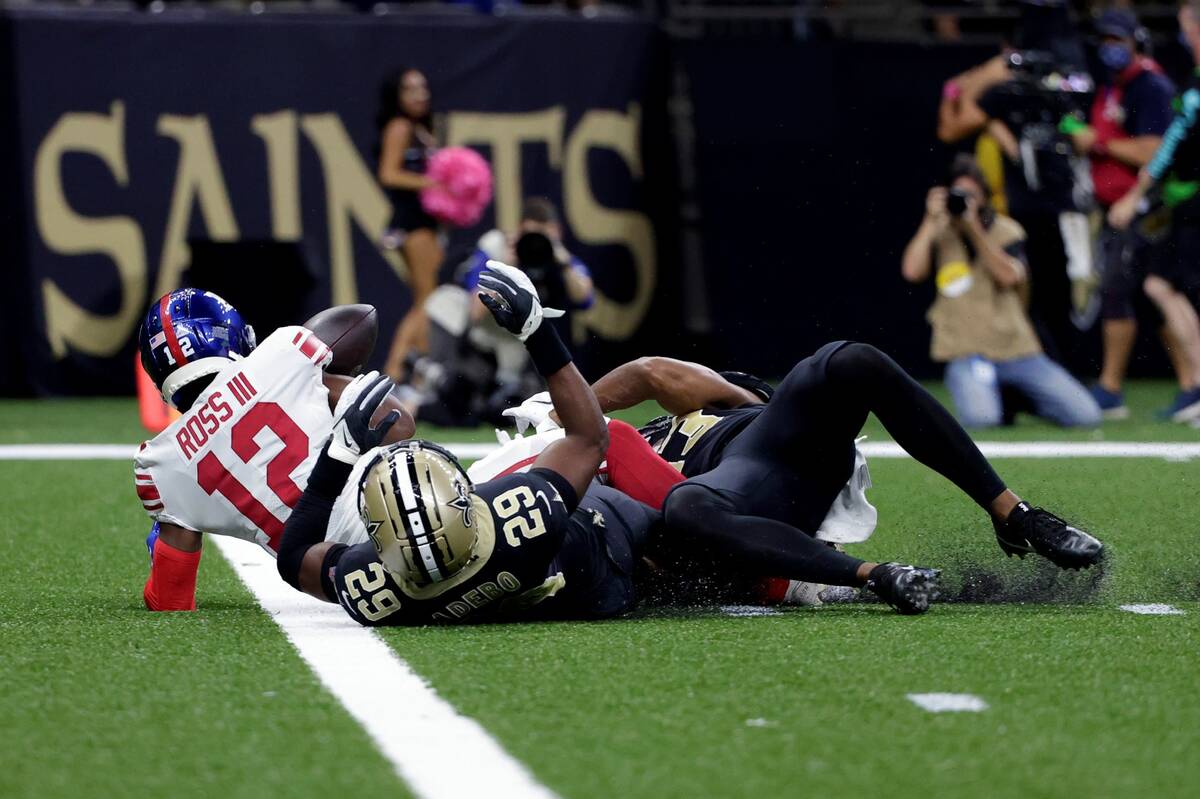 New York Giants wide receiver John Ross (12) loses the ball on a touchdown reception as he is t ...