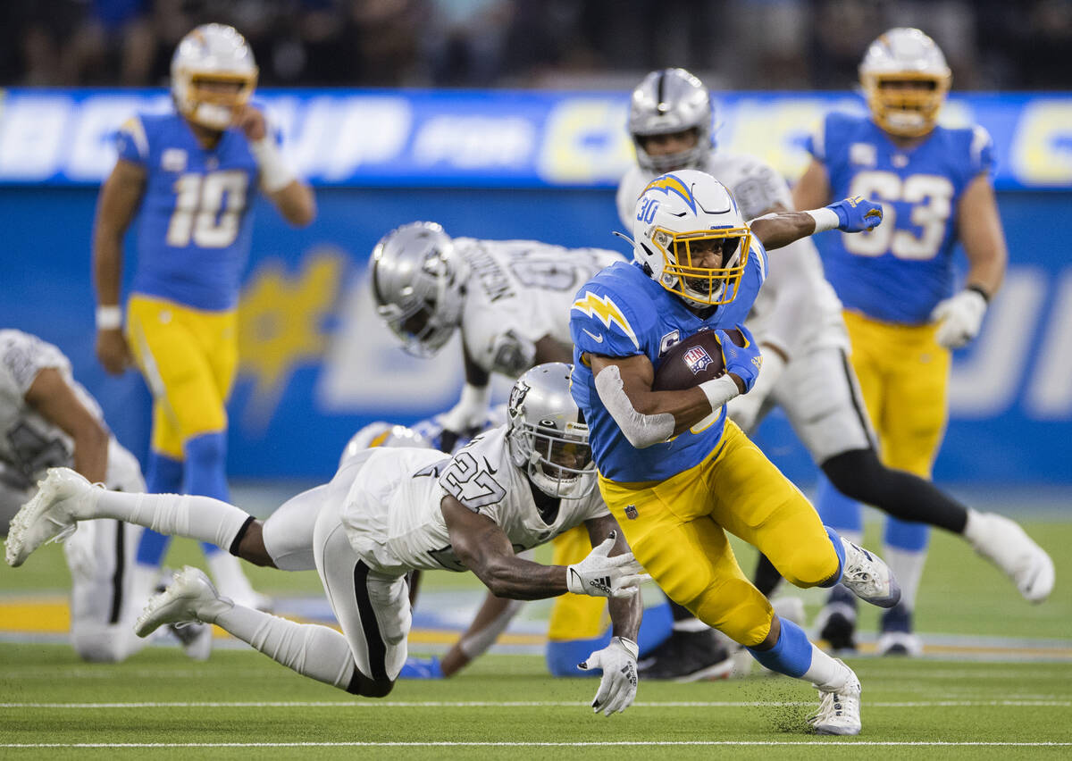 Los Angeles Chargers running back Austin Ekeler (30) breaks off a big run past Raiders cornerba ...