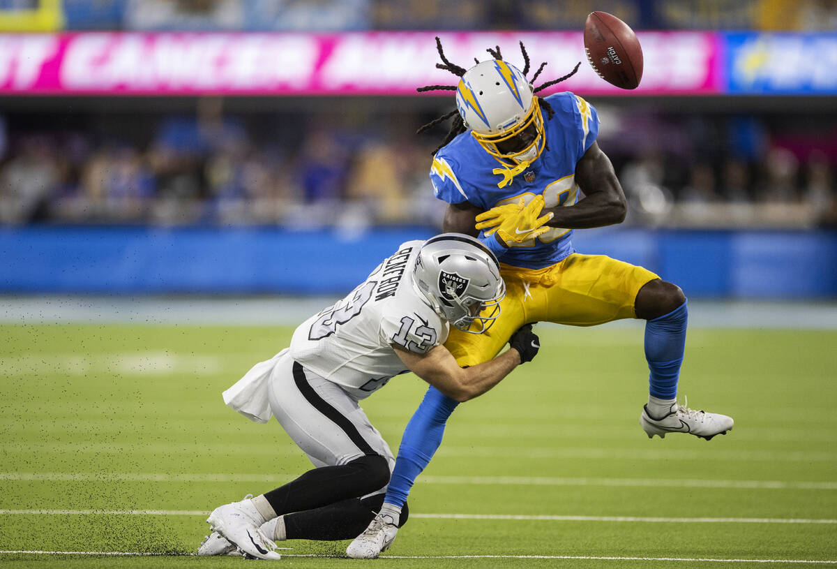 Raiders wide receiver Hunter Renfrow (13) breaks up a pass attempt to Los Angeles Chargers defe ...