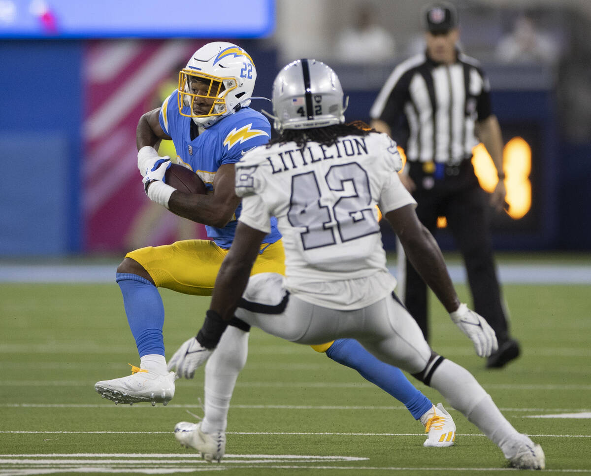 Los Angeles Chargers running back Justin Jackson (22) cuts up field past Raiders inside linebac ...