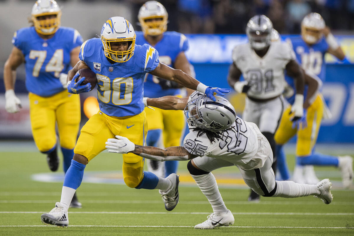Los Angeles Chargers running back Austin Ekeler (30) breaks off a big run past Raiders cornerba ...