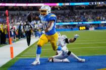Los Angeles Chargers running back Austin Ekeler scores a touchdown as Las Vegas Raiders outside ...