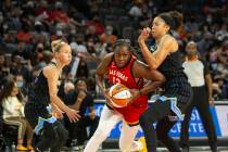 Las Vegas Aces guard Chelsea Gray (12) passes by Chicago Sky forward/center Candace Parker (3) ...