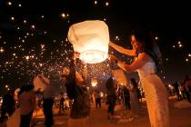 Luvia Williams, 8, of Scottsdale Ariz., left and her mother Whitney prepare their lantern for l ...