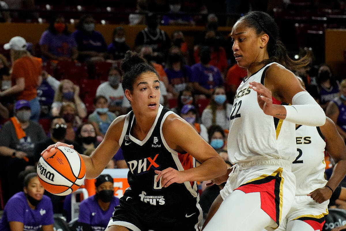 Phoenix Mercury guard Kia Nurse (0) drives on Las Vegas Aces forward A'ja Wilson during the fir ...